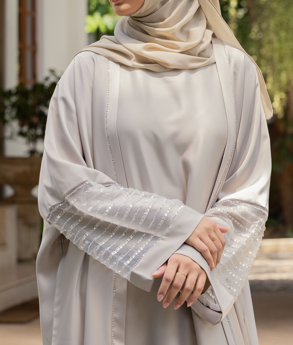 A luxury abaya dress design with tiered ruffle sleeves, perfect for those searching for an abaya shop near me.