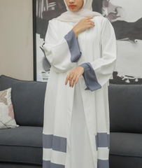 A modern white and grey open-style abaya dress from the latest abaya designs 2026 collection.