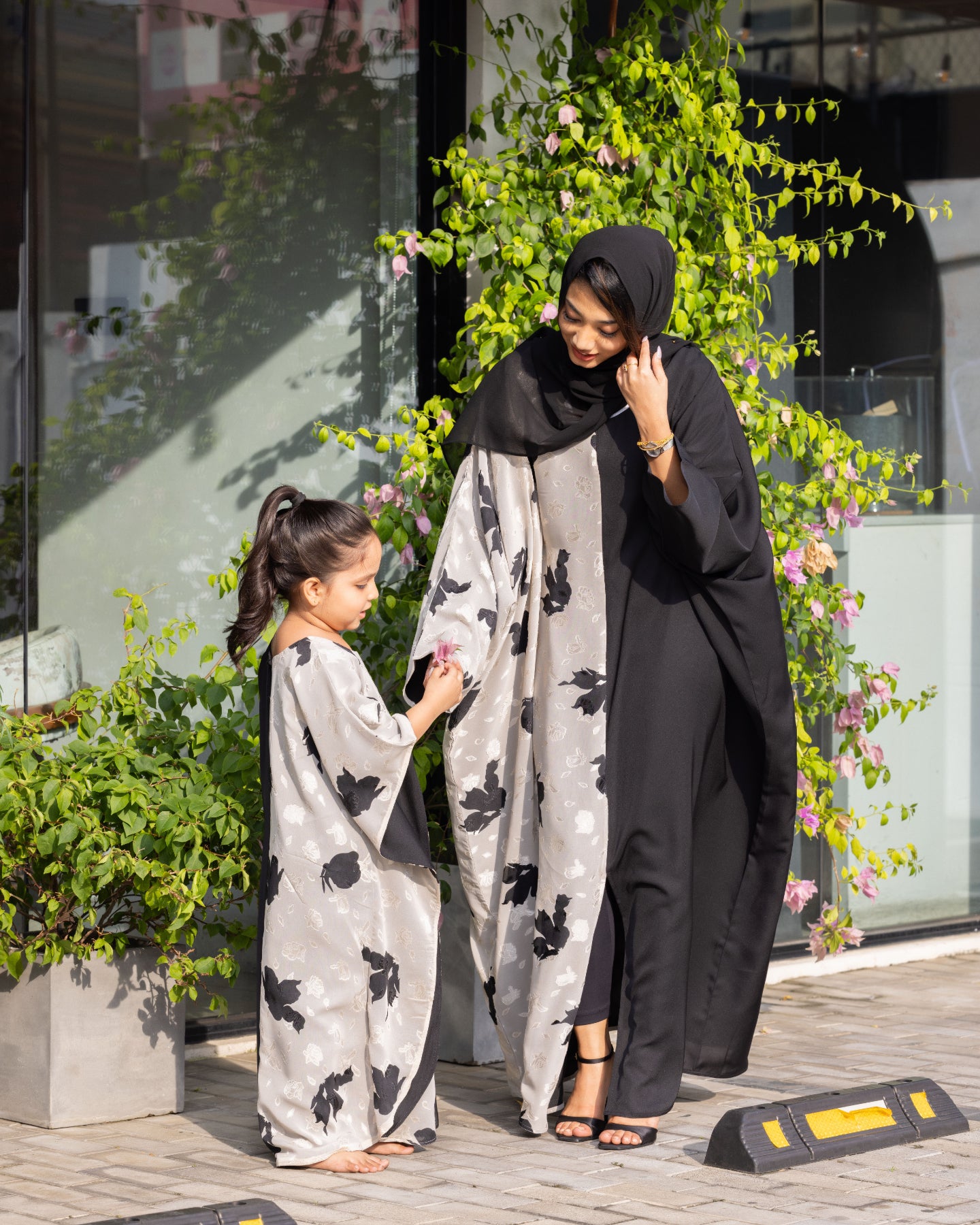 A beautiful matching abaya dress set featuring a two-tone floral and solid pattern, available at our online abaya shop.