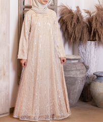 A glamorous cream abaya dress fully covered in sequins, available now at our abaya shop.