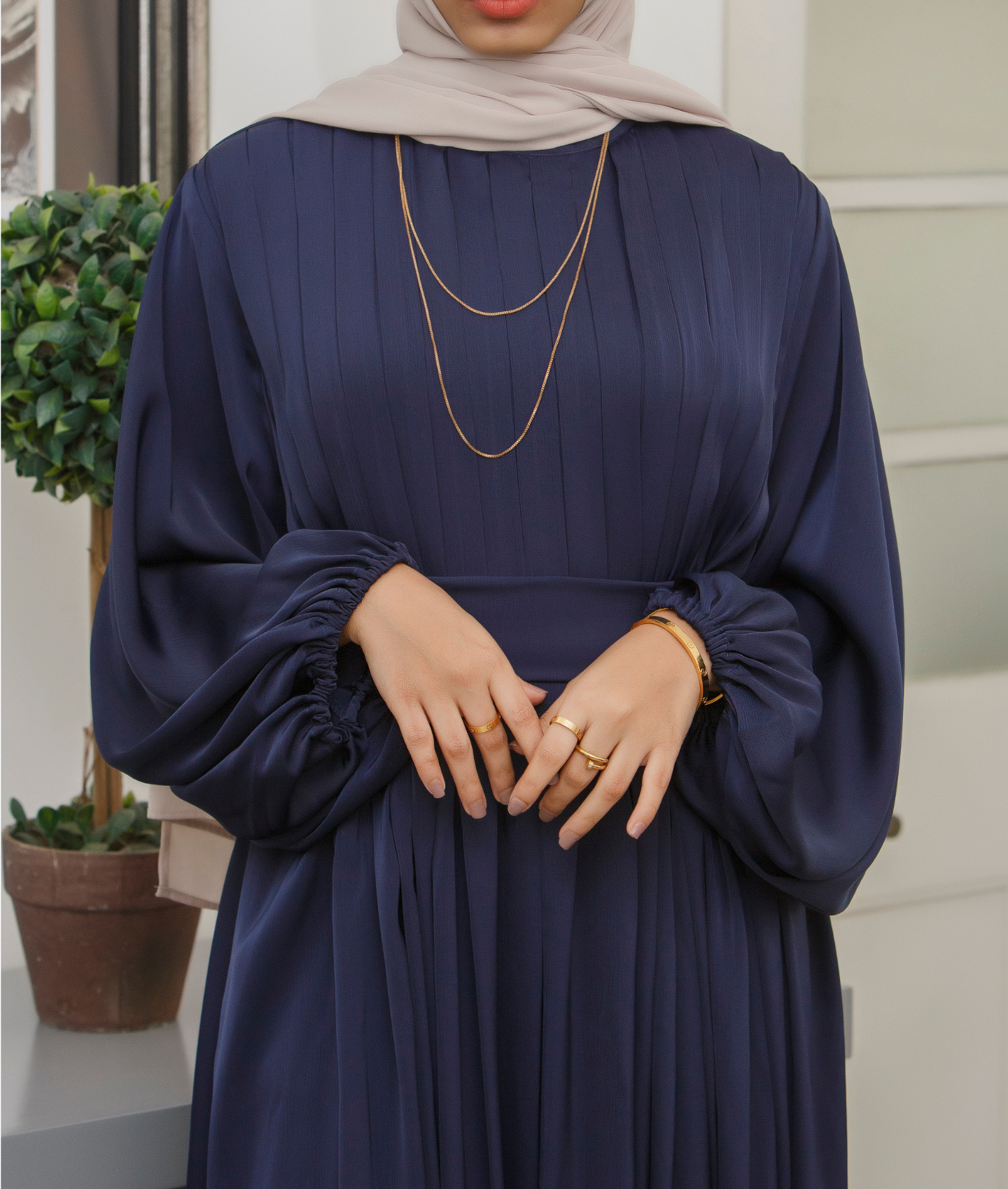 Elegant pleated abaya dress with bishop sleeves, ideal f abaya designs for formal events.
